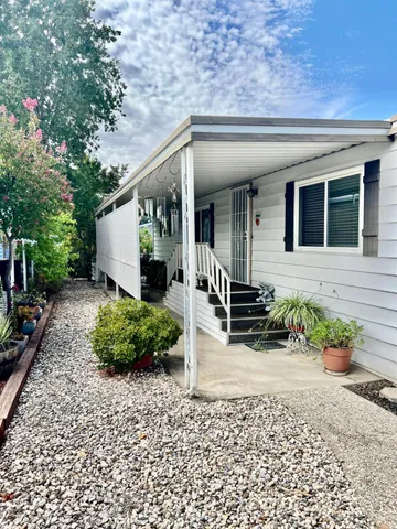 a view of a patio with table and chairs potted plants with wooden floor