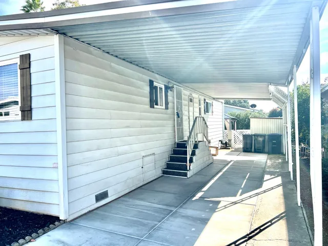a view of a wooden chairs and table in the balcony