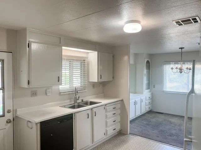 a kitchen with sink and window