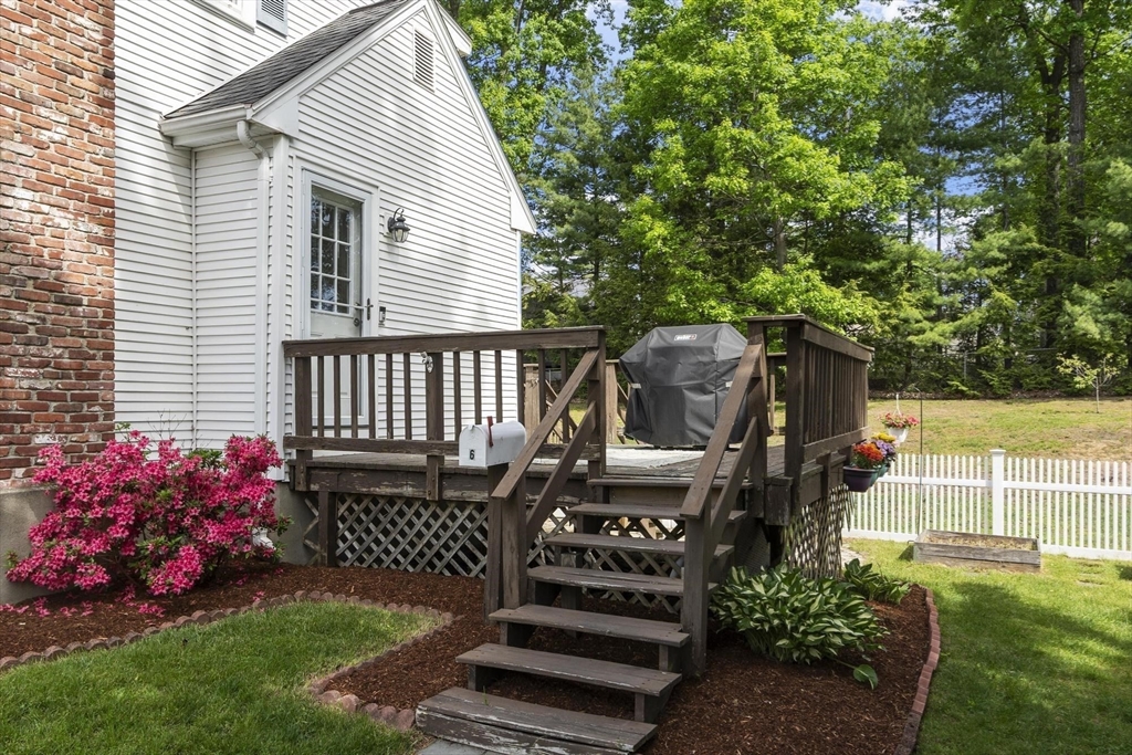 6 Edith Road Hudson, MA 01749 - Photo 27 of 30 a wooden bench sitting in front of a house