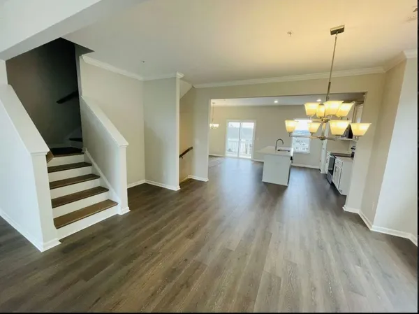 a view of a room with wooden floor and stairs