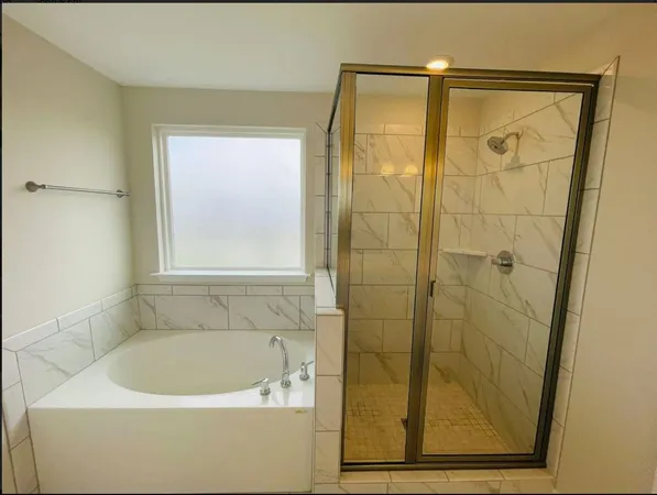 a bathroom with a bathtub and a shower