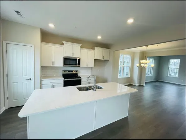 a kitchen with a sink a microwave a stove and refrigerator