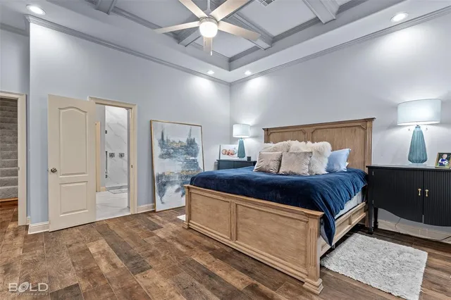 a bedroom with a large bed and a chandelier