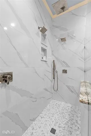 a bathroom with a granite countertop sink and bathtub