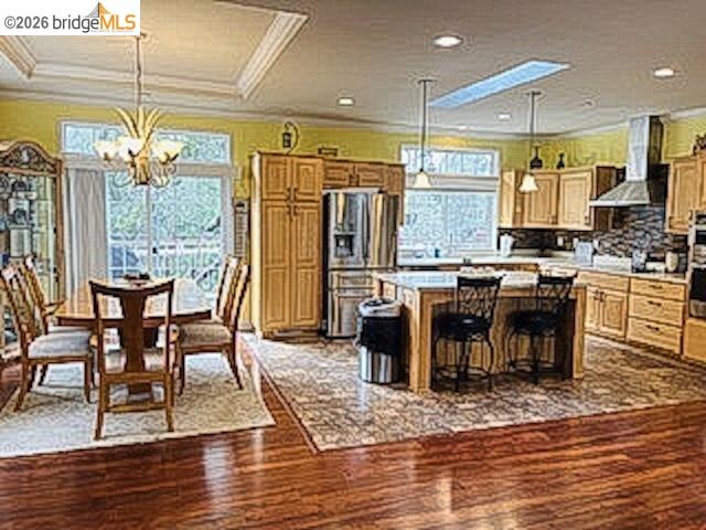 552 Bean Creek Road, Unit SPC 94 Scotts Valley, CA 95066 - Photo 6 of 23 a kitchen with stainless steel appliances granite countertop a stove top oven a refrigerator a dining table and chairs with wooden floor