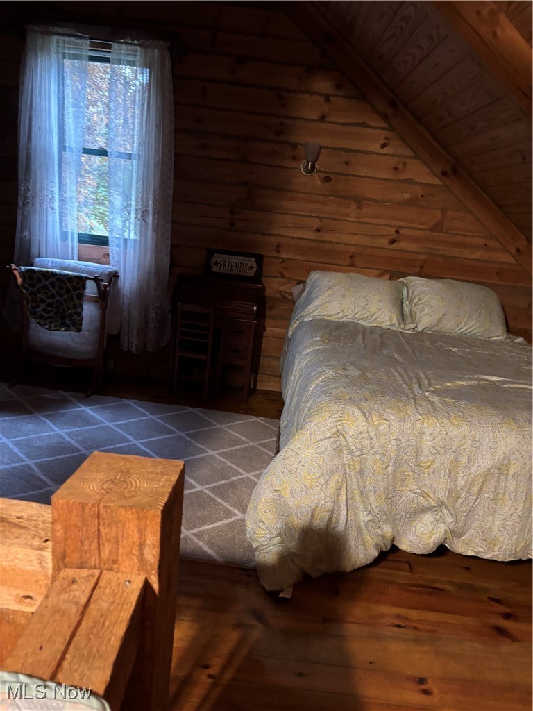 55249 Jim Ball Road Senecaville, OH 43780 - Photo 14 of 14 Bedroom featuring wooden walls, hardwood / wood-style flooring, and lofted ceiling