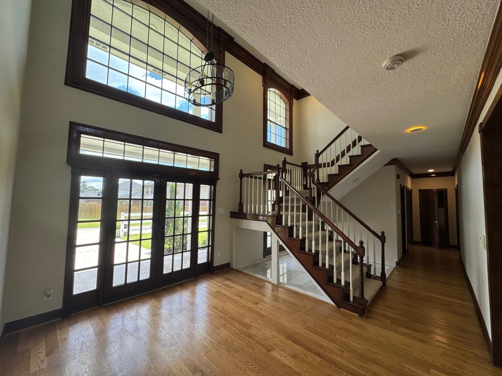 27165 Kestrel Trail Magnolia, TX 77354 - Photo 6 of 50 Welcome to a grand foyer featuring soaring ceilings, abundant natural light, and a stunning staircase, setting the tone for elegance throughout the home.