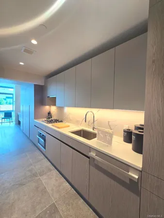 a large kitchen with kitchen island a sink stainless steel appliances and cabinets
