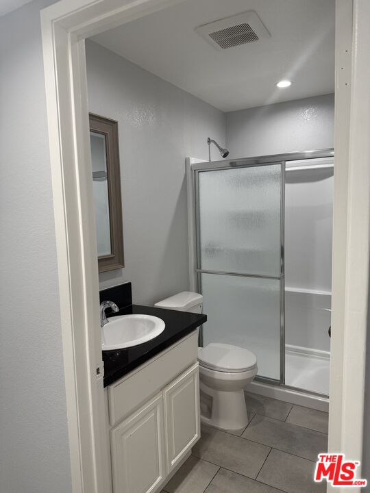 7639 Kester Avenue, Unit 1 Van Nuys, CA 91405 - Photo 12 of 21 a bathroom with a granite countertop sink toilet and shower
