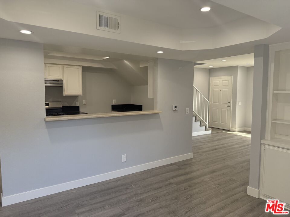 7639 Kester Avenue, Unit 1 Van Nuys, CA 91405 - Photo 2 of 21 an empty room with wooden floor and windows