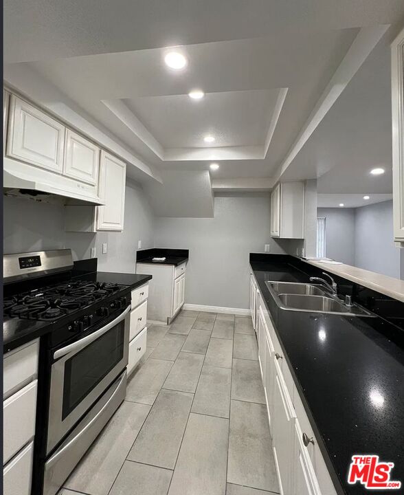 7639 Kester Avenue, Unit 1 Van Nuys, CA 91405 - Photo 3 of 21 a kitchen with granite countertop a stove and a sink