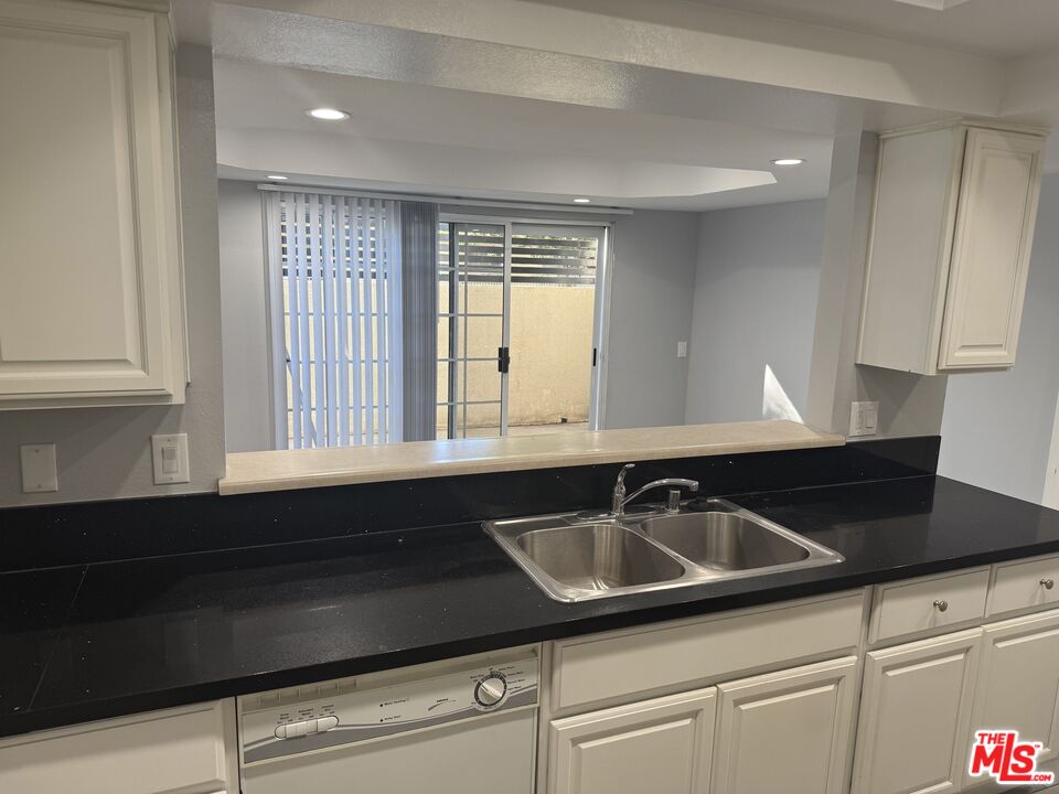 7639 Kester Avenue, Unit 1 Van Nuys, CA 91405 - Photo 4 of 21 a kitchen that has a sink and cabinets