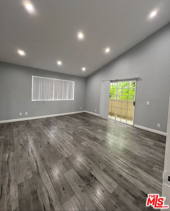 7639 Kester Avenue, Unit 1 Van Nuys, CA 91405 - Photo 7 of 21 an empty room with wooden floor and windows