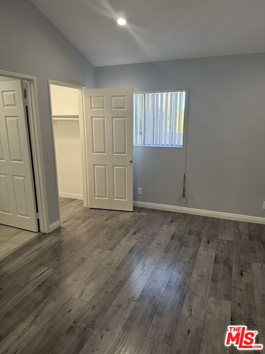7639 Kester Avenue, Unit 1 Van Nuys, CA 91405 - Photo 8 of 21 an empty room with wooden floor and windows