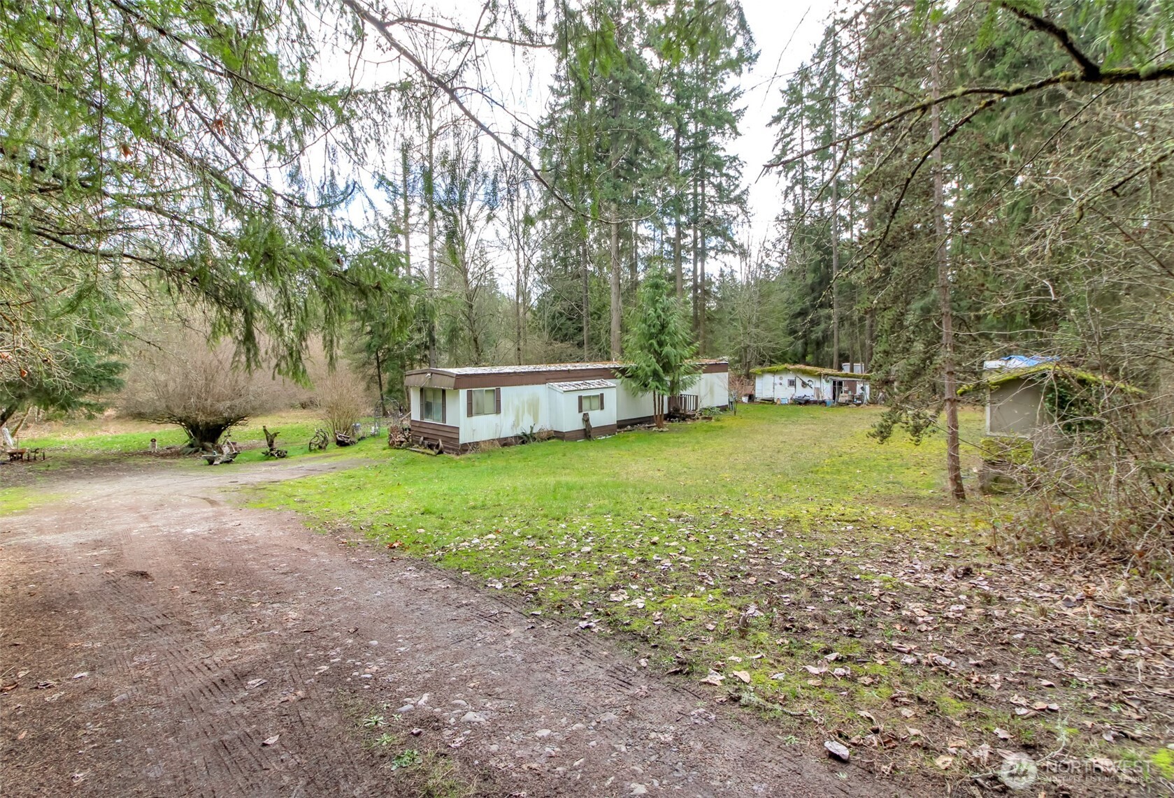 7308 335th St Court South Roy, WA 98580 - Photo 2 of 21 a view of a house with backyard and trees