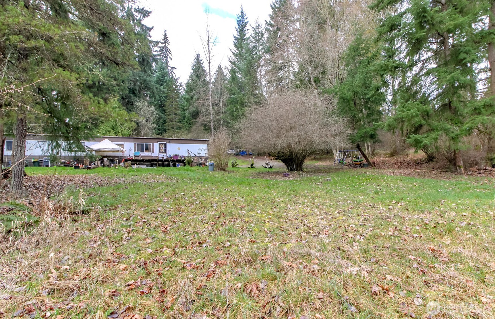 7308 335th St Court South Roy, WA 98580 - Photo 8 of 21 a view of a house with a yard and sitting area