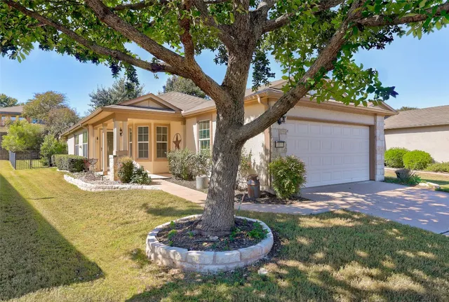 a front view of a house with a yard and a porch