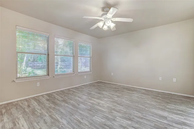 wooden floor in an empty room with a window