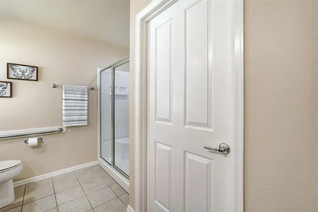 a bathroom with a shower and toilet