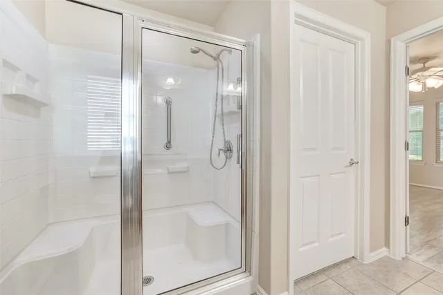 a bathroom with a glass shower door