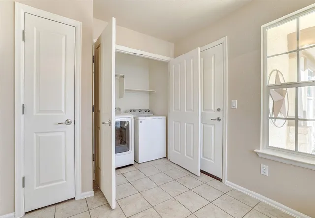 a view of a storage & utility room with a window