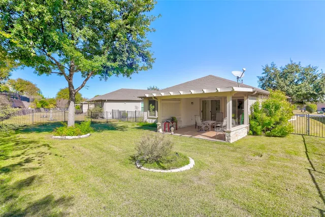 a front view of a house with swimming pool and furniture