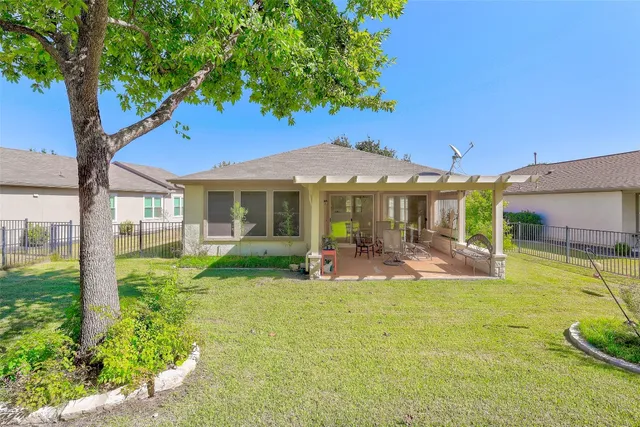 a front view of a house with swimming pool having outdoor seating