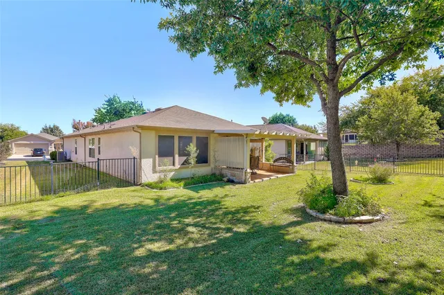 a view of a house with backyard and sitting area