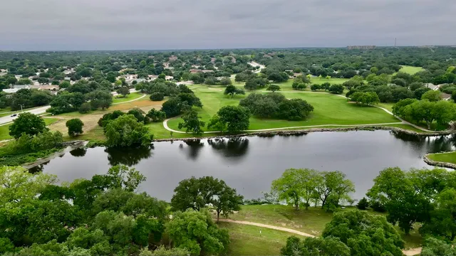 an aerial view of a houses with a lake view