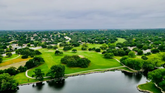 a view of a golf course with parking space