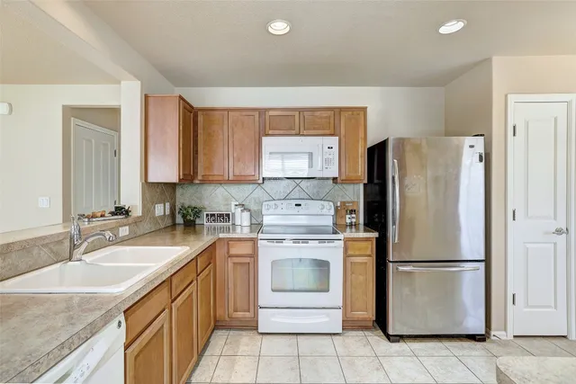 a kitchen with a refrigerator sink and stove