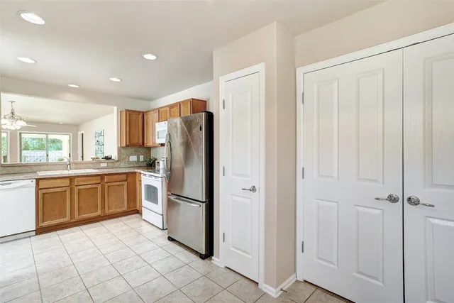 a kitchen with stainless steel appliances granite countertop a refrigerator and a sink