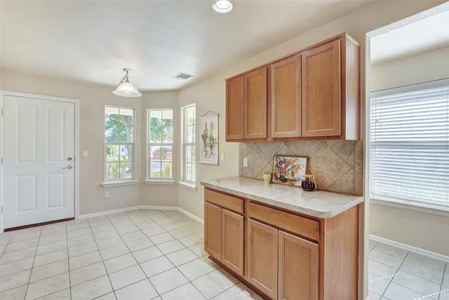a kitchen with a sink cabinets and window