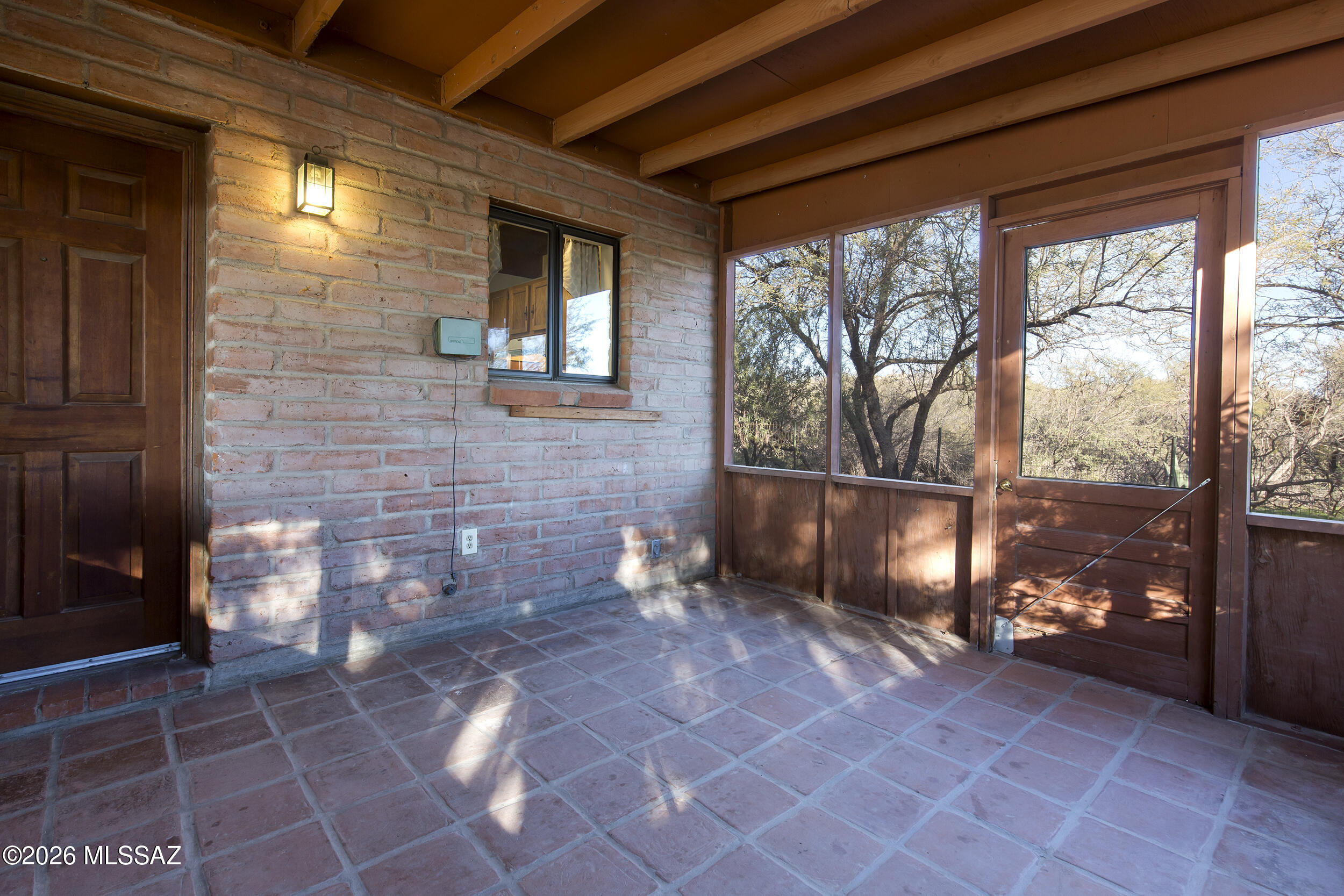 4130 East River Road Tucson, AZ 85718 - Photo 41 of 46 a view of a porch with a table and chairs and potted plants