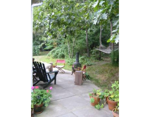 22 Scraggy Neck Road Bourne, MA 02534 - Photo 3 of 4 a view of a patio with table and chairs and potted plants