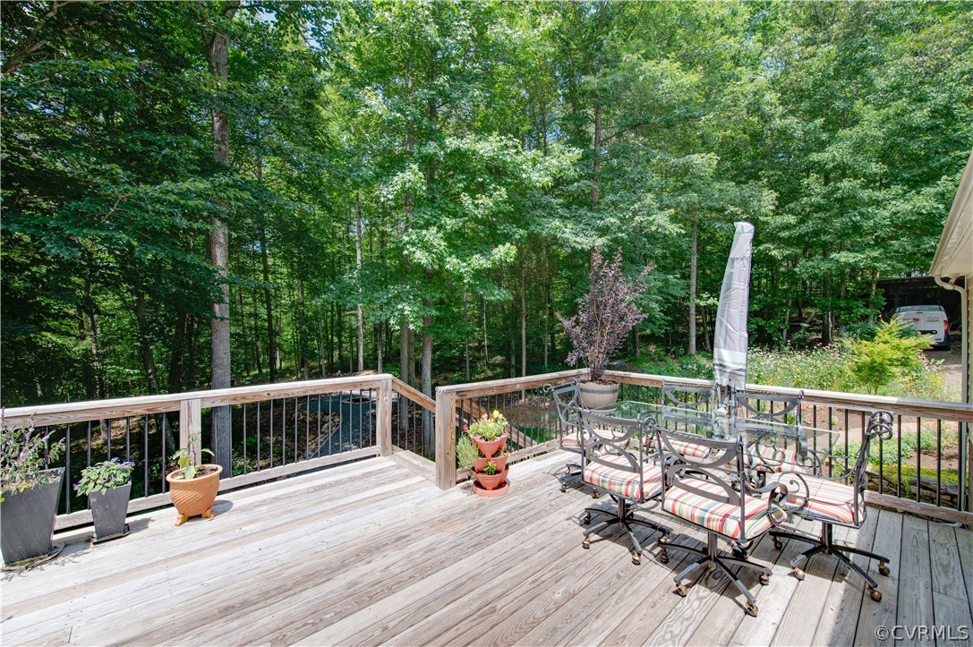 3940 Whitehall Road Sandy Hook, VA 23153 - Photo 17 of 49 a view of deck with furniture and trees around