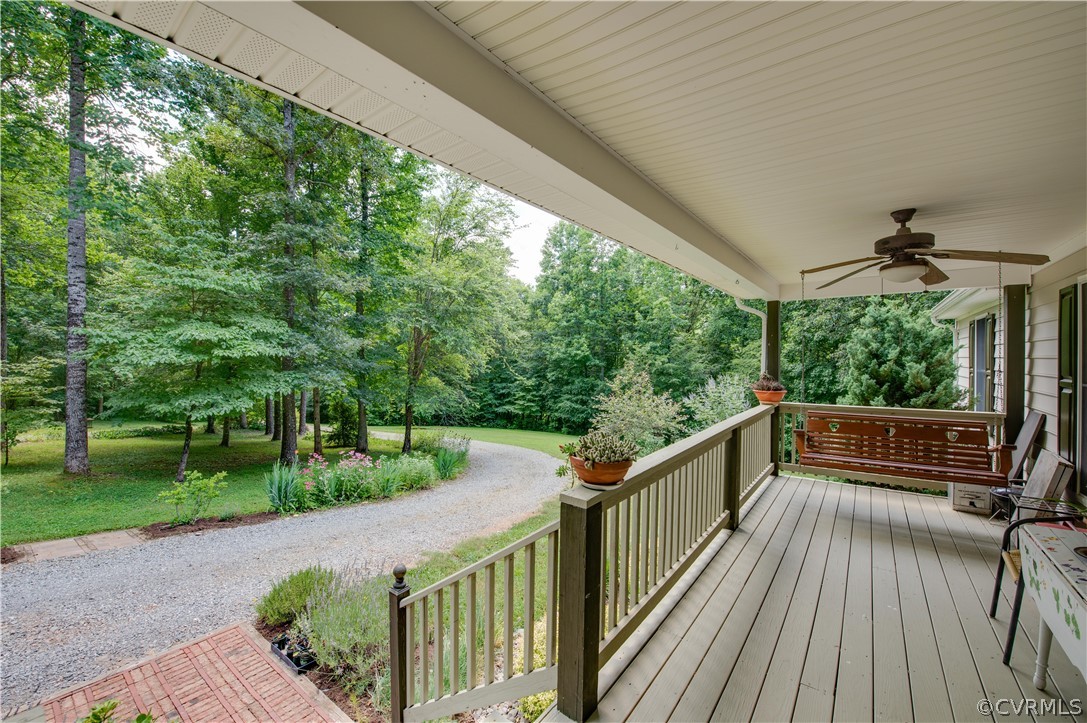 3940 Whitehall Road Sandy Hook, VA 23153 - Photo 21 of 49 a view of a balcony with chairs and wooden floor