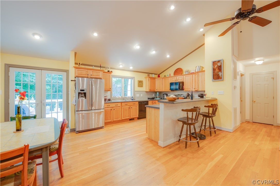 3940 Whitehall Road Sandy Hook, VA 23153 - Photo 25 of 49 a kitchen with stainless steel appliances kitchen island granite countertop a table chairs and a refrigerator