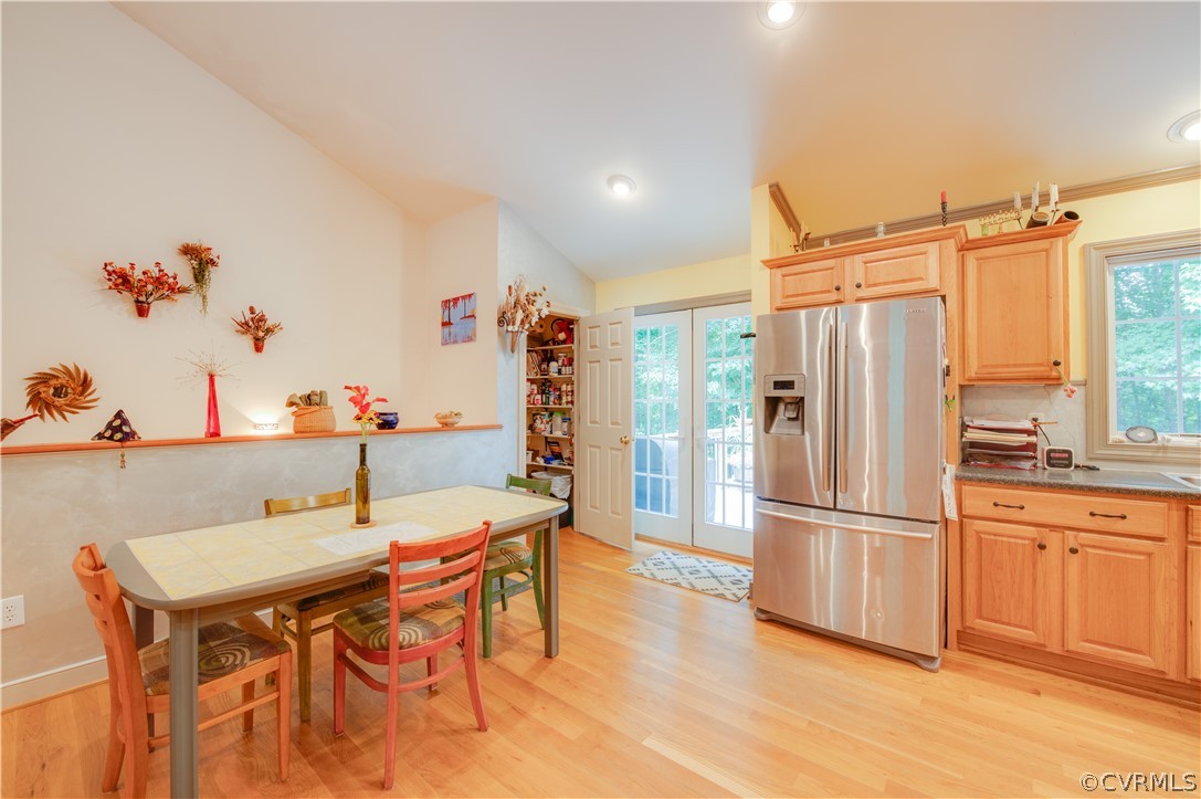 3940 Whitehall Road Sandy Hook, VA 23153 - Photo 29 of 49 a kitchen with stainless steel appliances a dining table chairs and refrigerator