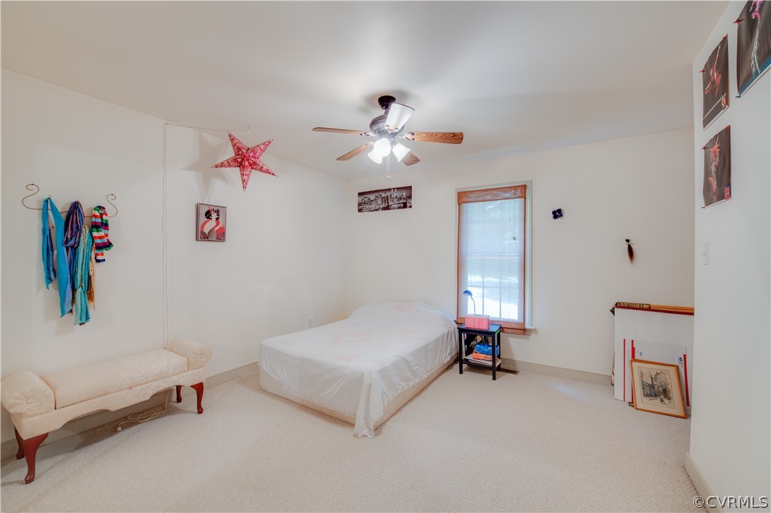 3940 Whitehall Road Sandy Hook, VA 23153 - Photo 31 of 49 a bedroom with furniture and a chandelier