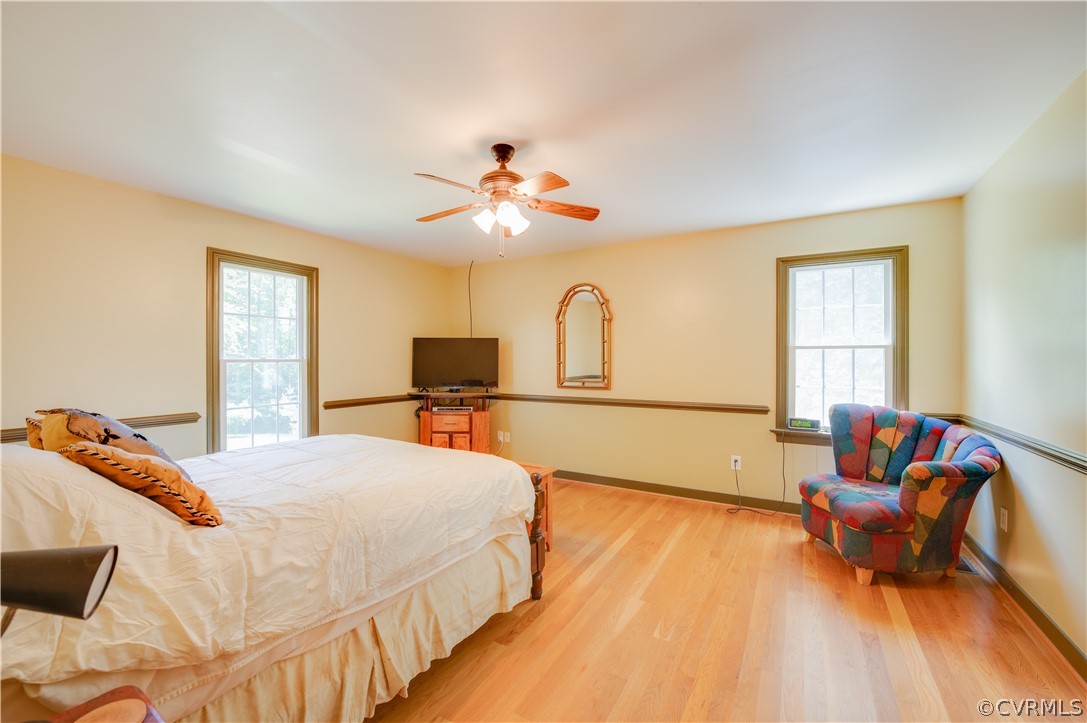 3940 Whitehall Road Sandy Hook, VA 23153 - Photo 34 of 49 a bedroom with a bed and a chandelier
