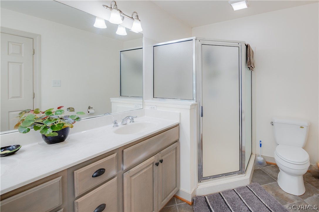 3940 Whitehall Road Sandy Hook, VA 23153 - Photo 39 of 49 a bathroom with a sink and mirror with toilet
