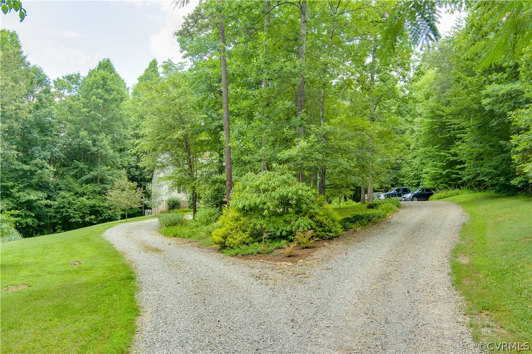 3940 Whitehall Road Sandy Hook, VA 23153 - Photo 4 of 49 a view of a street with a yard and a fountain