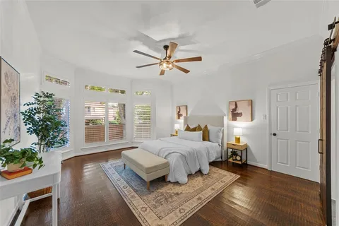 a bedroom with a bed potted plant with the outer view
