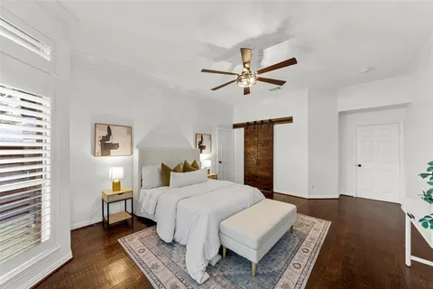 a bedroom with a large bed and a chandelier