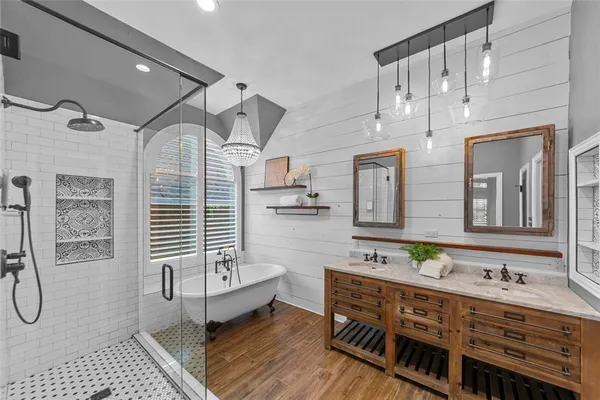 a bathroom with a double vanity sink a mirror and a shower