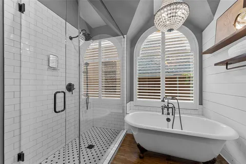 a bathroom with a tub sink and shower