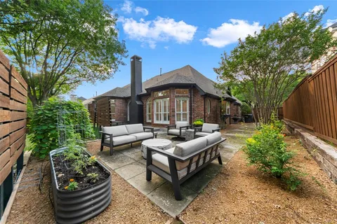 a view of a patio with couches table and chairs and potted plants