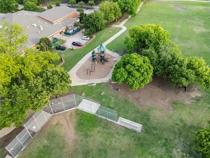 an aerial view of a house with a yard